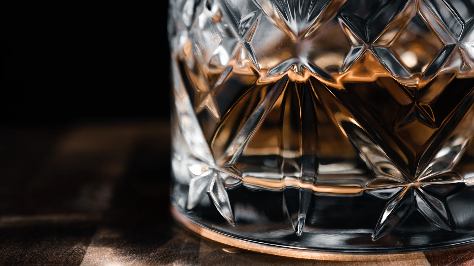Glass of whiskey on a wooden table — Aggravated DUI in Oklahoma