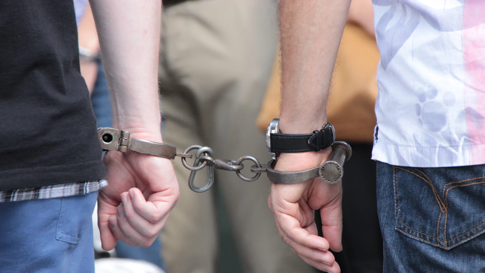 Hands in handcuffs — Felon in possession of a firearm in Oklahoma
