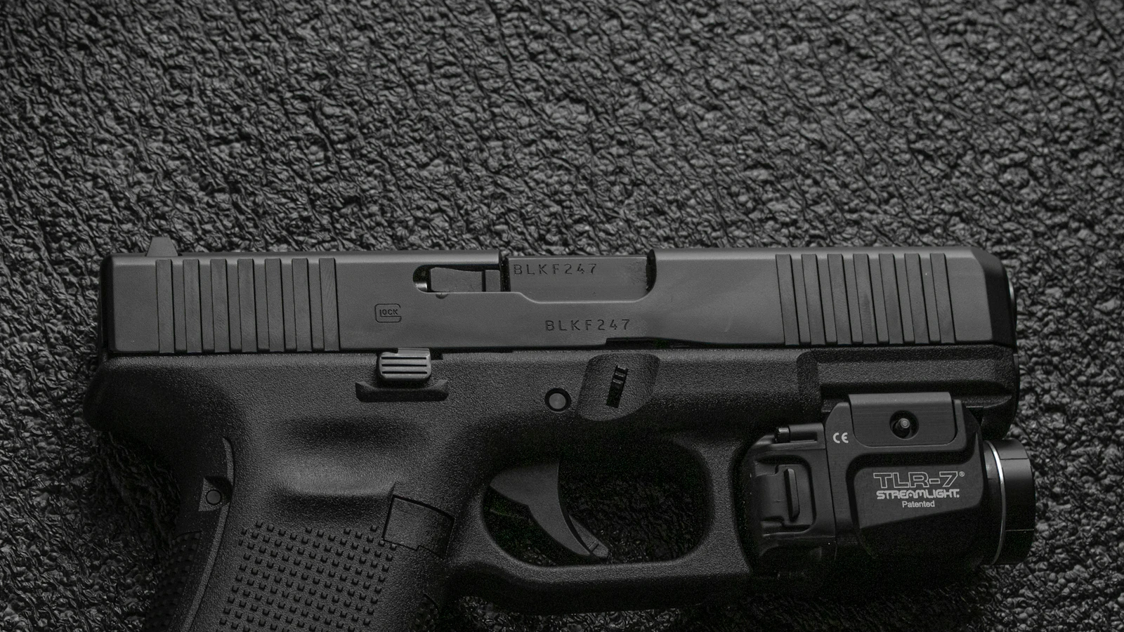 Semi-automatic pistol on gray fabric — Unlawful carry in Oklahoma